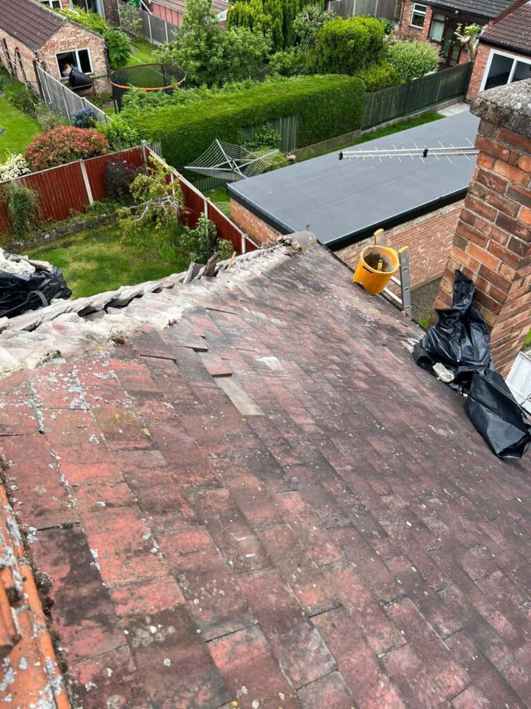 This is a photo of a roof where the hip tiles have been removed, and are just about to be replaced. Works carried out by Hucknall Roofing Repairs